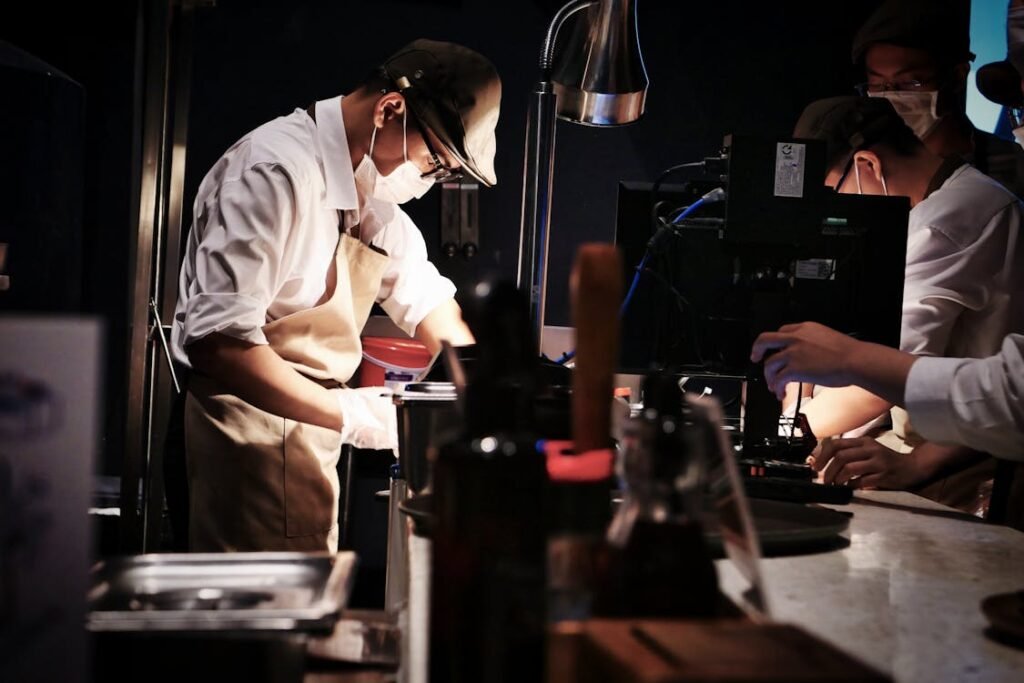 How Much Does a Chef Earn in India? Role-by-Role Salary Breakdown (2026) 1 Professional chefs in white uniforms working together in a busy restaurant kitchen.