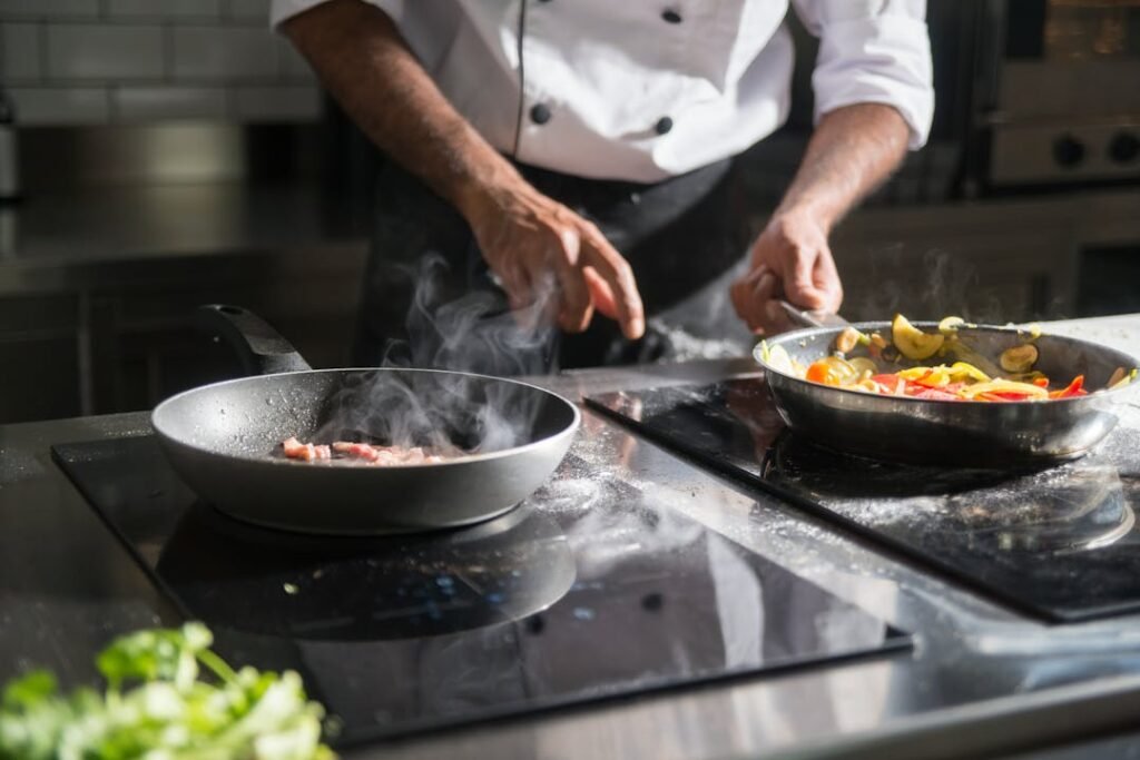 Cooking Classes in Ahmedabad for Beginners: What to Expect, What to Learn, and Where to Start (2026) 7 Professional chef cooking on a gas stove in a well-equipped culinary training kitchen.