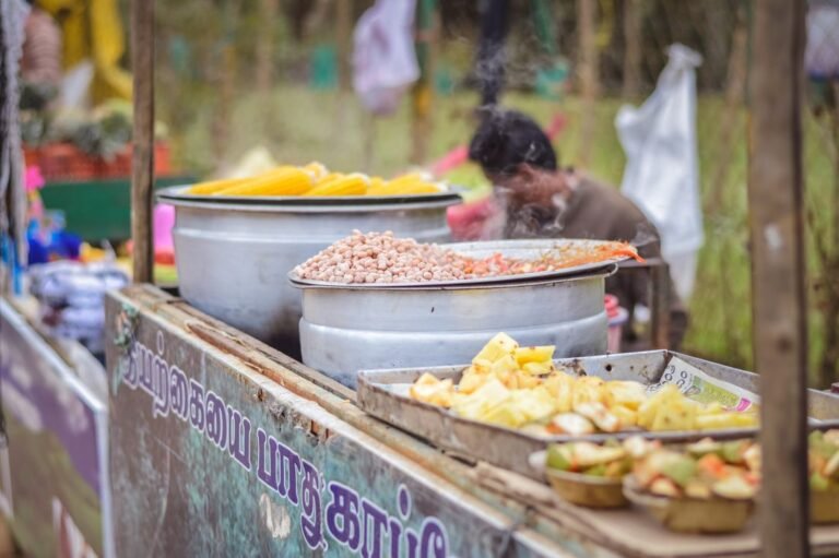 Vibrant Indian street food stall showcasing steaming dishes and colourful ingredients at a busy Ahmedabad market.