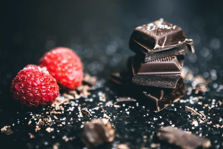 Luxury chocolate gifting box with assorted truffles and bonbons arranged on dark background