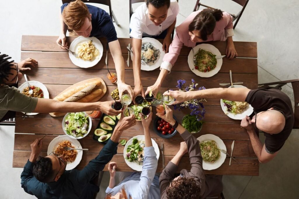 How to Enrol at Florence Academy Ahmedabad: Courses, Admission Process, and Key Dates 8 A culinary educator in white chef's coat discussing course materials with a student at a kitchen counter in a professional training classroom.