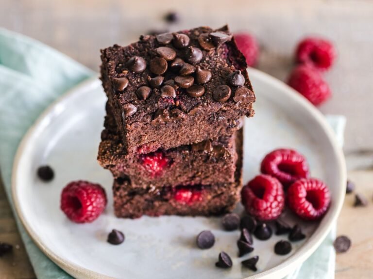 Stacked fudgy chocolate brownie squares with raspberries