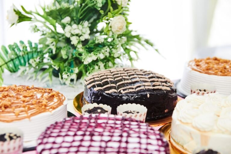 A variety of delicious cakes with chocolate and cream toppings displayed in a bakery