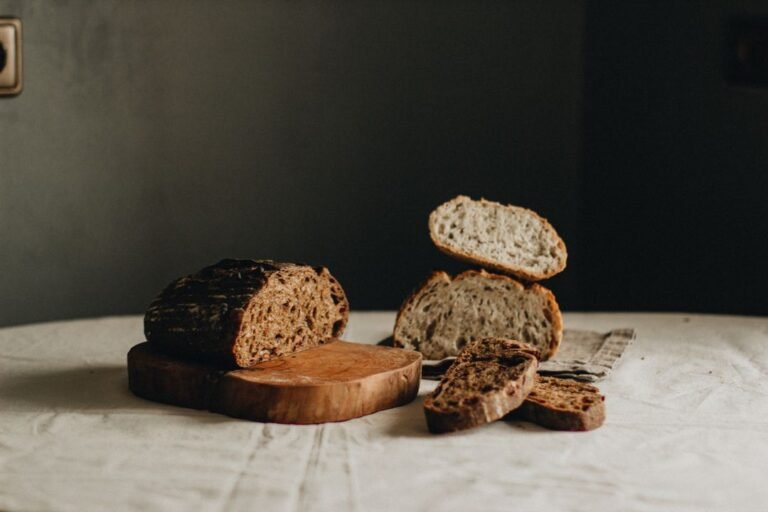 Rustic sourdough loaves sliced open showing airy crumb and crackly crust