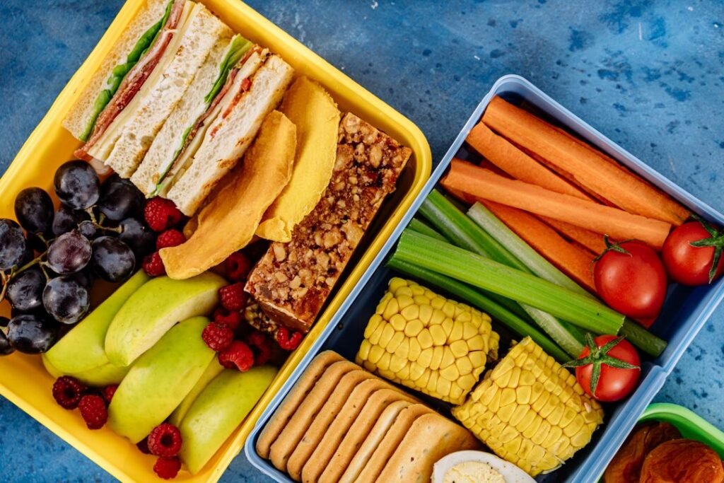 A packed lunchbox of sandwiches, fresh vegetables and fruit prepared ahead for the week.