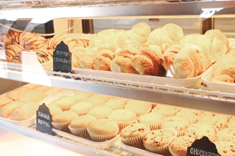 A bakery display of freshly baked croissants showing their laminated, flaky layers.