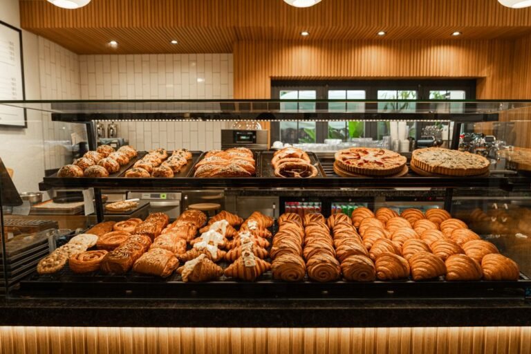 A cozy bakery counter displaying a wide variety of freshly baked pastries.