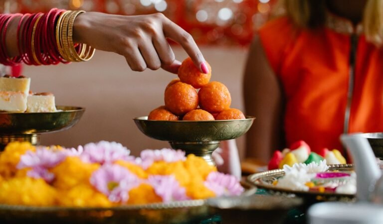 A festive table laid with traditional Indian sweets and dishes for a religious celebration.