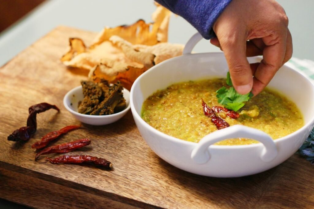 A bowl of simple Indian khichdi garnished with fresh coriander, a staple vrat-friendly dish.