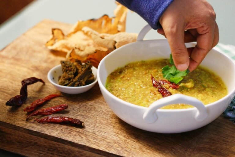 A bowl of simple Indian khichdi garnished with fresh coriander, a staple vrat-friendly dish.
