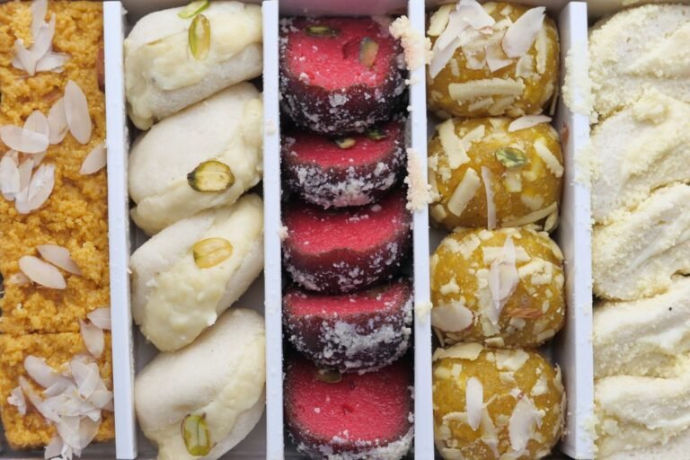 A platter of Indian sweets topped with almonds, pistachios and coconut, prepared for a family celebration.