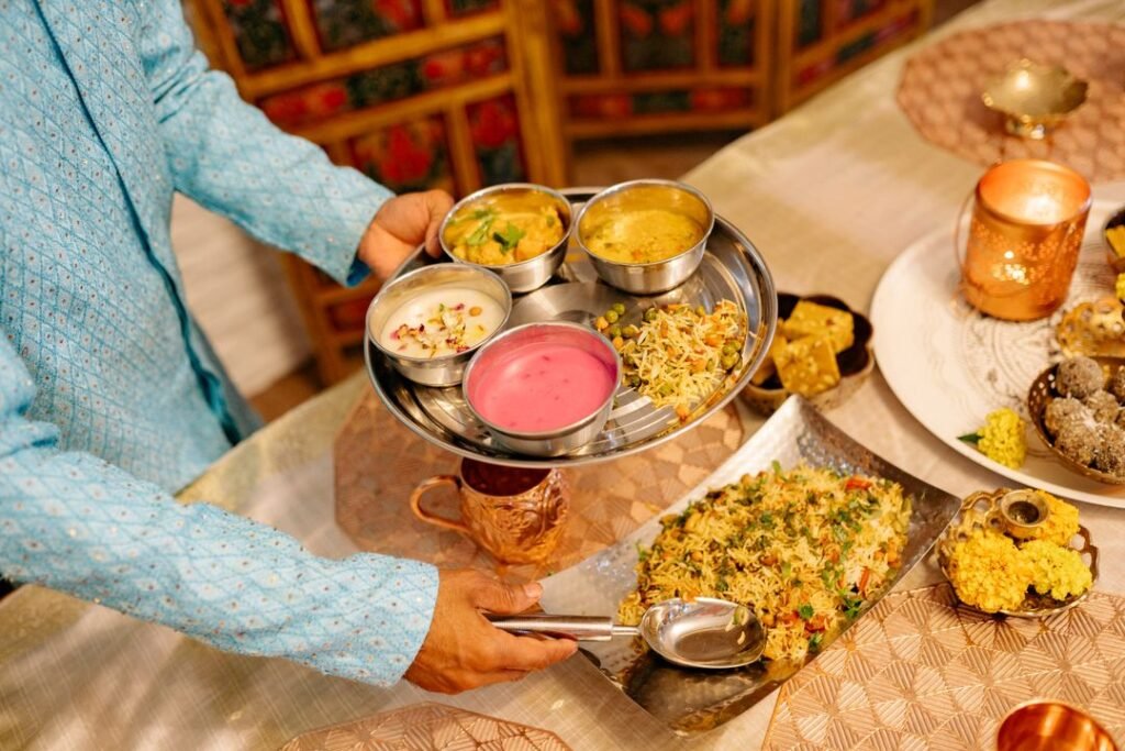 The Story Behind Gujarati Thali: Every Dish Explained 6 A traditional Indian vegetarian thali being served, showing the many small dishes that make up one plate.